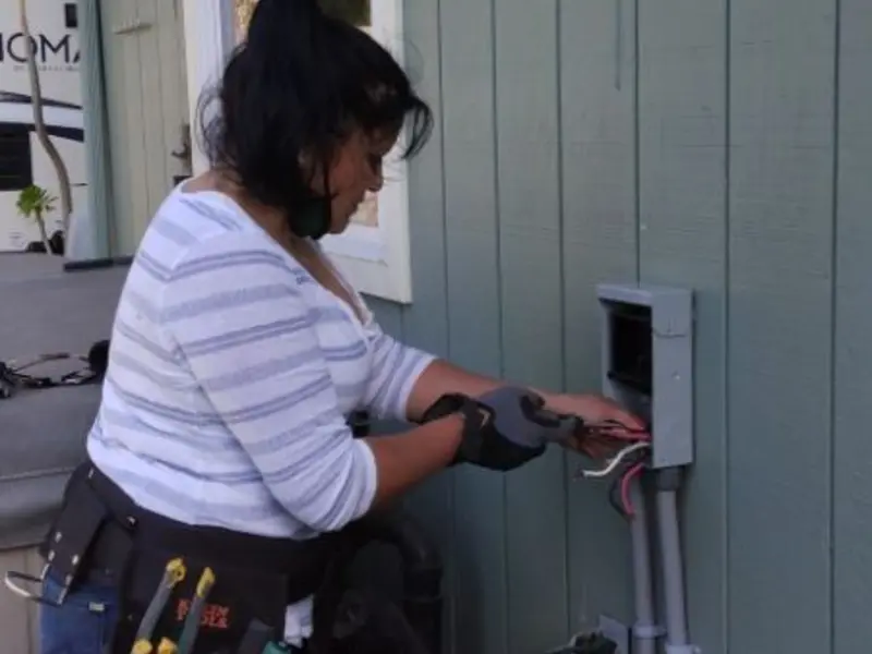 Licensed electrician wiring an exterior subpanel in North St. Paul